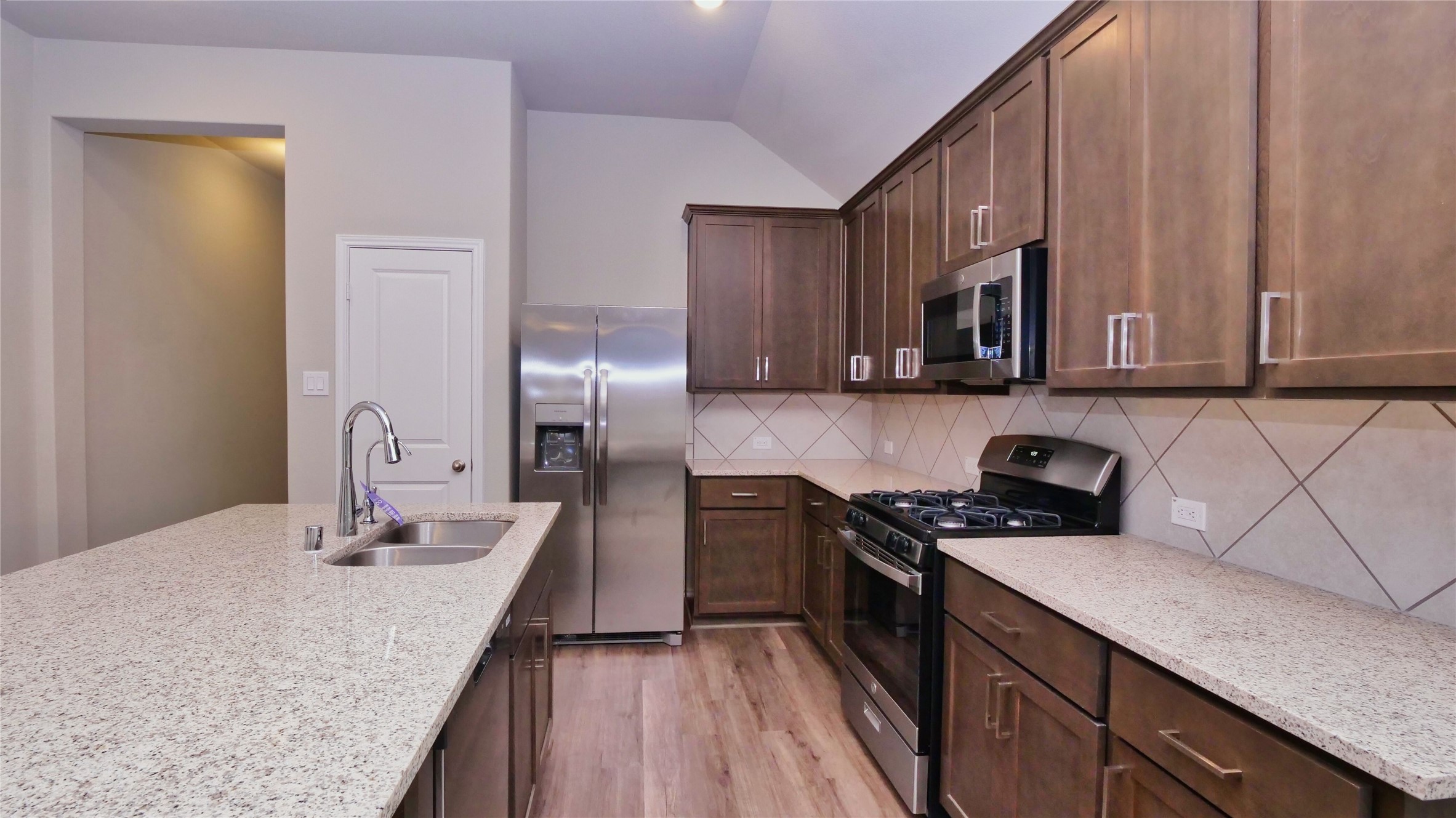 7343 Mount Greylock Loop Porter, TX 77365 - Photo 6 of 17 a kitchen with stainless steel appliances granite countertop a sink stove and refrigerator