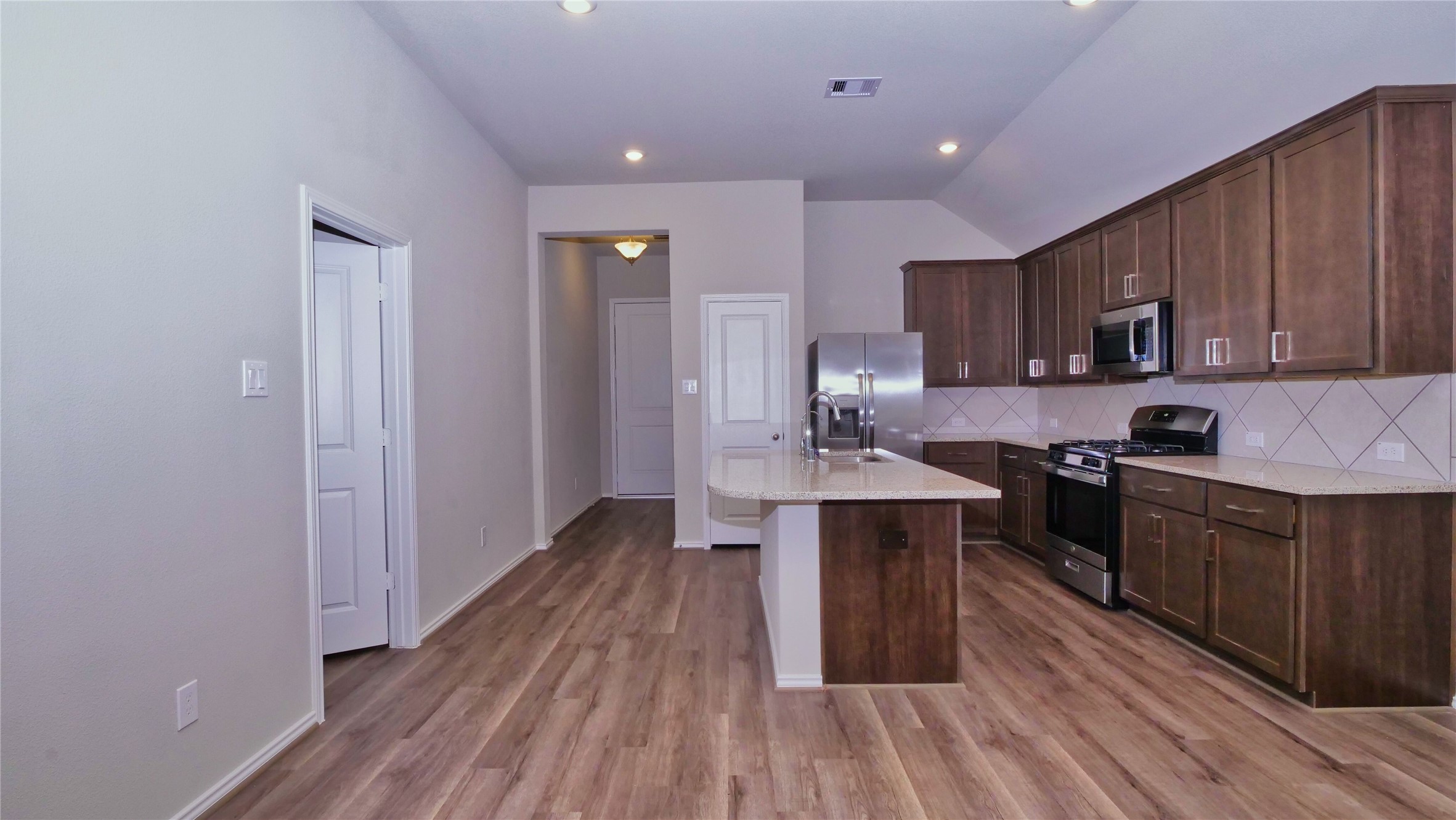7343 Mount Greylock Loop Porter, TX 77365 - Photo 7 of 17 a kitchen with a sink and wooden cabinets