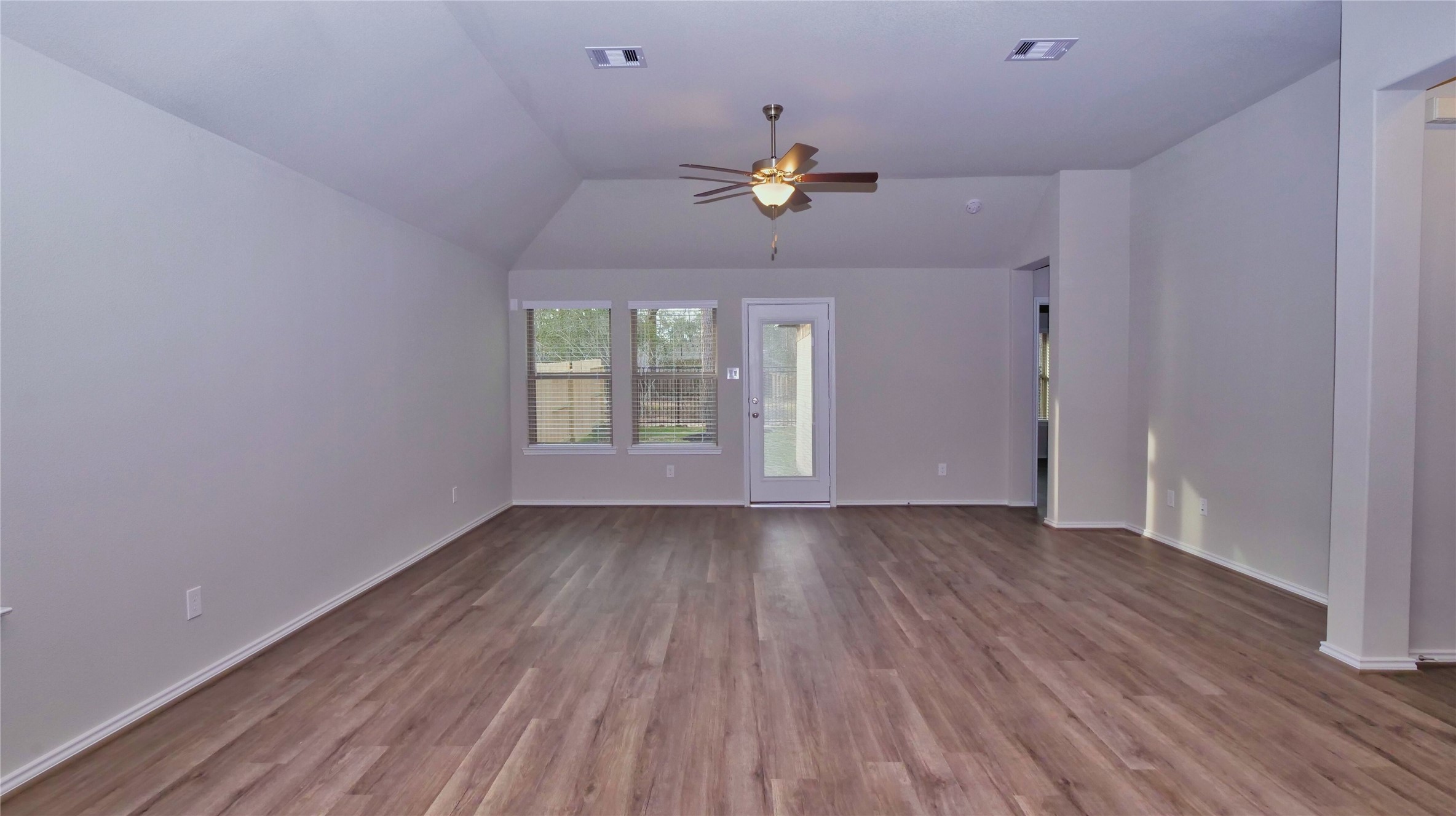 7343 Mount Greylock Loop Porter, TX 77365 - Photo 8 of 17 wooden floor in an empty room with a window