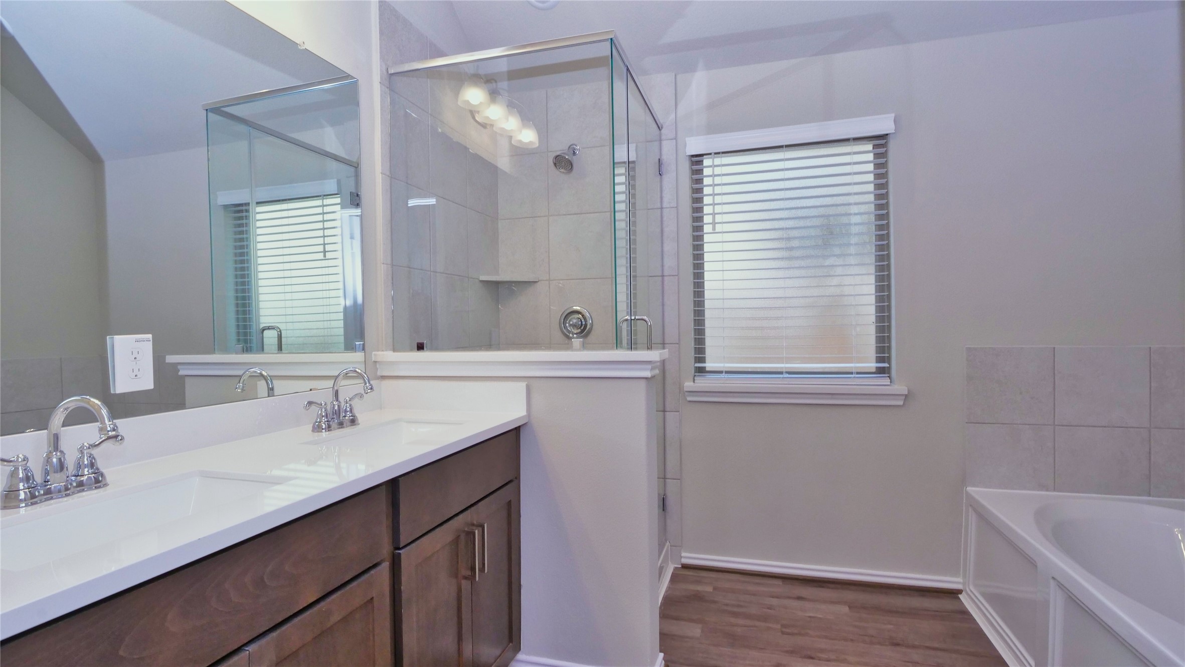 7343 Mount Greylock Loop Porter, TX 77365 - Photo 10 of 17 a bathroom with a sink double vanity granite tub shower and a mirror