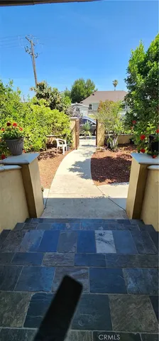 a backyard of a house with barbeque oven and outdoor seating