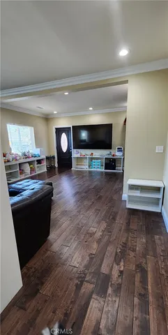 a room with a bed and a wooden floor