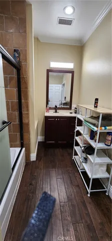 a living room with wooden floor and furniture