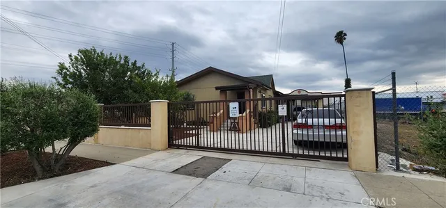 a front view of a house with a garden and plants