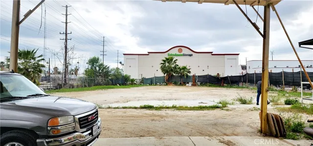 a view of a dirt road with a building in the background