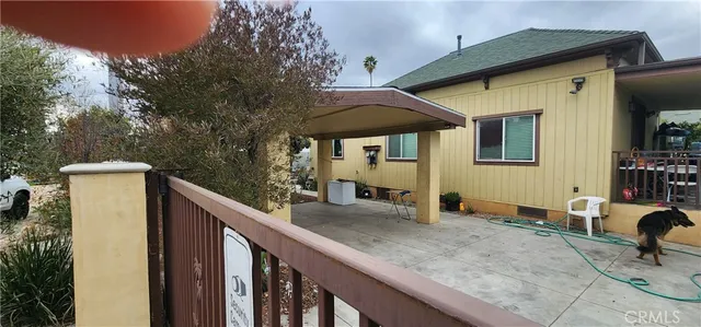a view of a house with backyard and sitting area