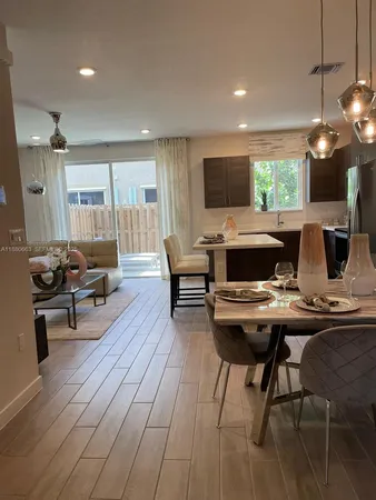 a living room with furniture a flat screen tv and a table