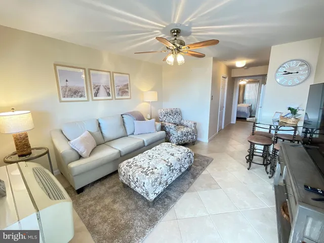 a living room with furniture and a lamp