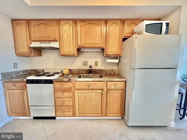 a kitchen with appliances a sink and a window