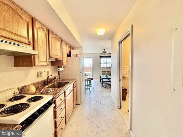 a kitchen with a sink and a stove top oven