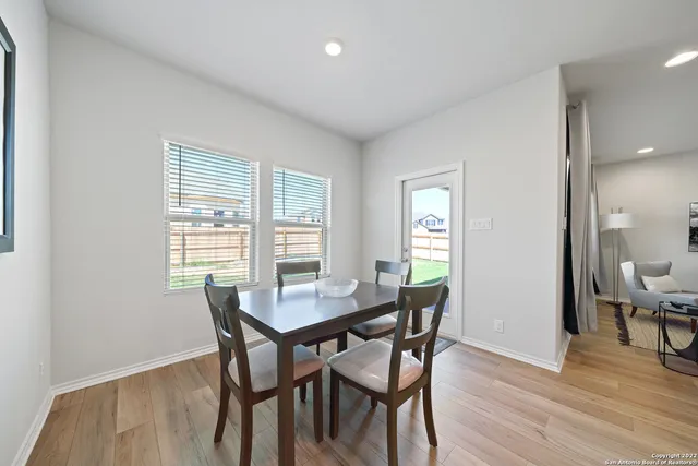 a view of a dining room with furniture and wooden floor