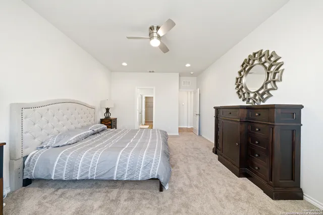 a bedroom with a bed and a dresser