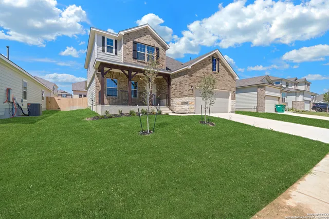 a view of a house with a yard and a porch