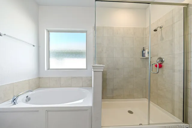 a white bath tub sitting next to a shower