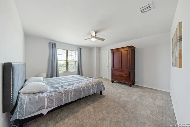 a bedroom with a bed closet and a window