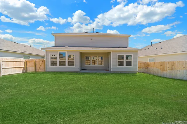 a view of a house with a backyard