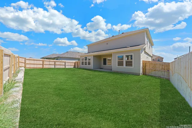 a view of a house with a backyard