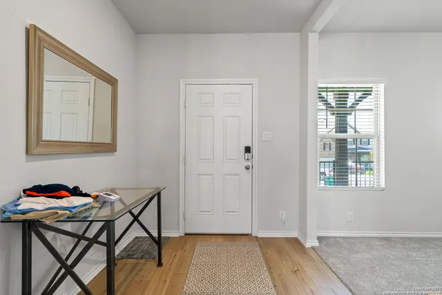 a view of a room that has a table and chair in it