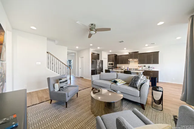 a living room with furniture and kitchen view