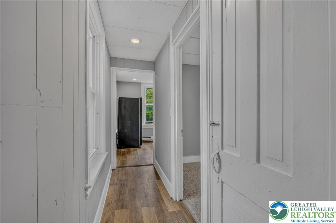 313 Main Street Slatington, PA 18080 - Photo 48 of 73 A well-lit corridor with recessed lighting and warm wood flooring creates an inviting pathway.