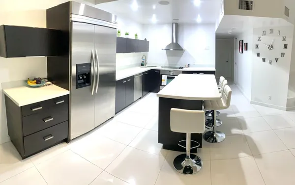 a room with table chairs and refrigerator