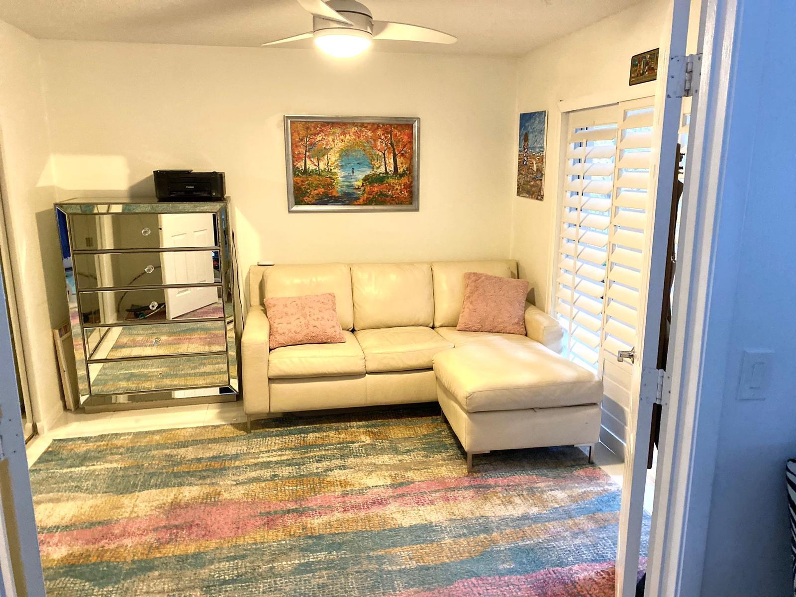 13770 Oneida Drive, Unit B2 Delray Beach, FL 33446 - Photo 12 of 14 a living room with furniture and a table