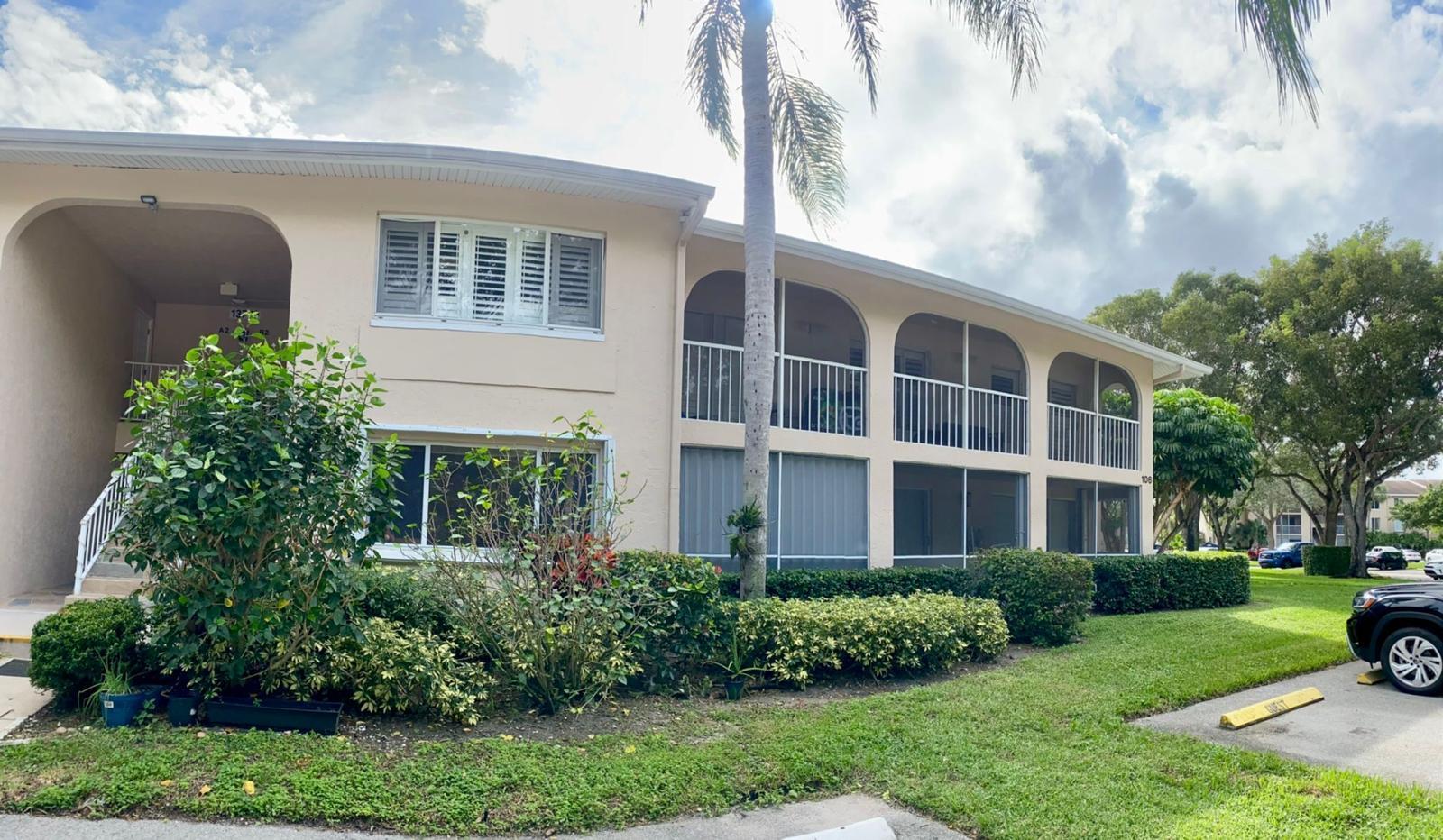 13770 Oneida Drive, Unit B2 Delray Beach, FL 33446 - Photo 2 of 14 a front view of a building with garden