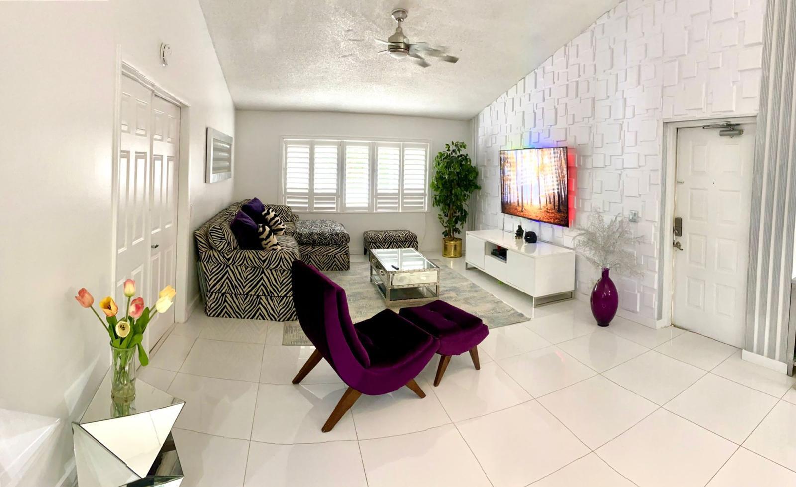13770 Oneida Drive, Unit B2 Delray Beach, FL 33446 - Photo 3 of 14 a living room with furniture a flat screen tv and a window
