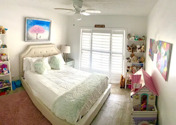 a bedroom with a bed and a large window