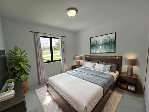 a bedroom with a bed and a potted plant