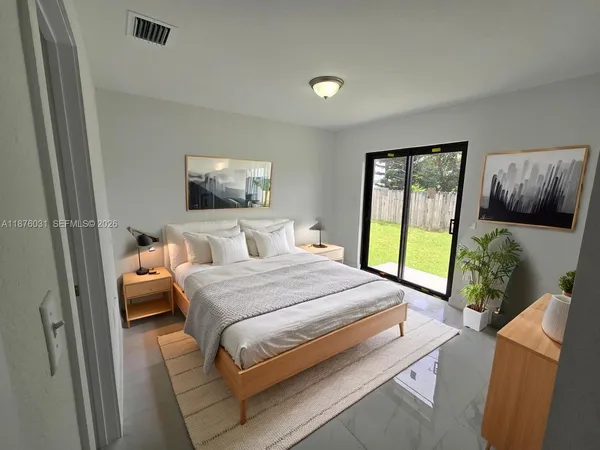 a bedroom with a bed and glass window