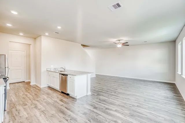 a view of a kitchen with a sink and a refrigerator
