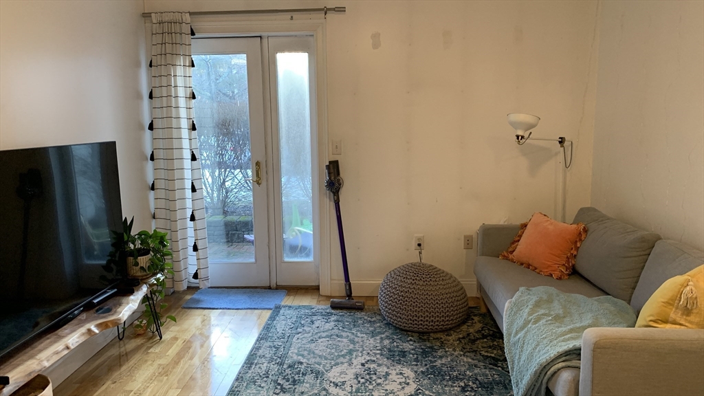 25 Alpine Street, Unit 10 Boston, MA 02136 - Photo 7 of 18 a bedroom with a bed and a flat screen tv