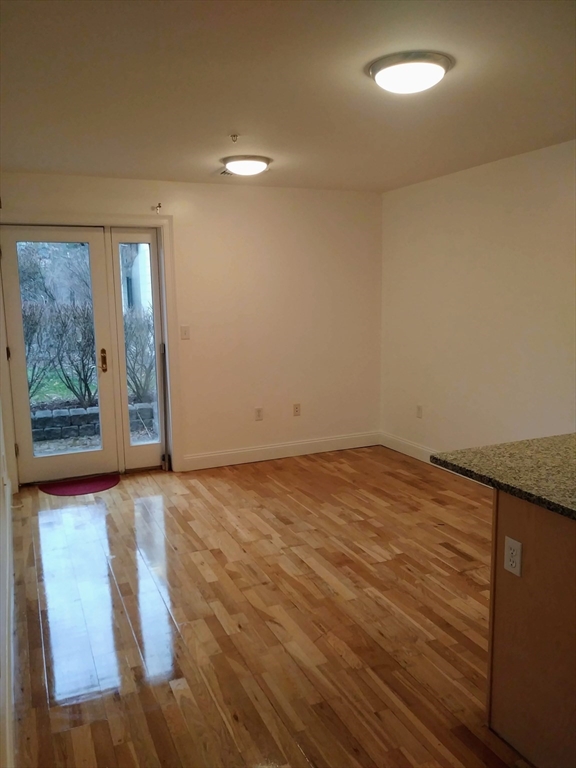25 Alpine Street, Unit 10 Boston, MA 02136 - Photo 8 of 18 an empty room with wooden floor and window