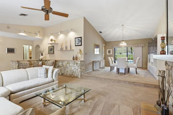 a living room with furniture and a dining table