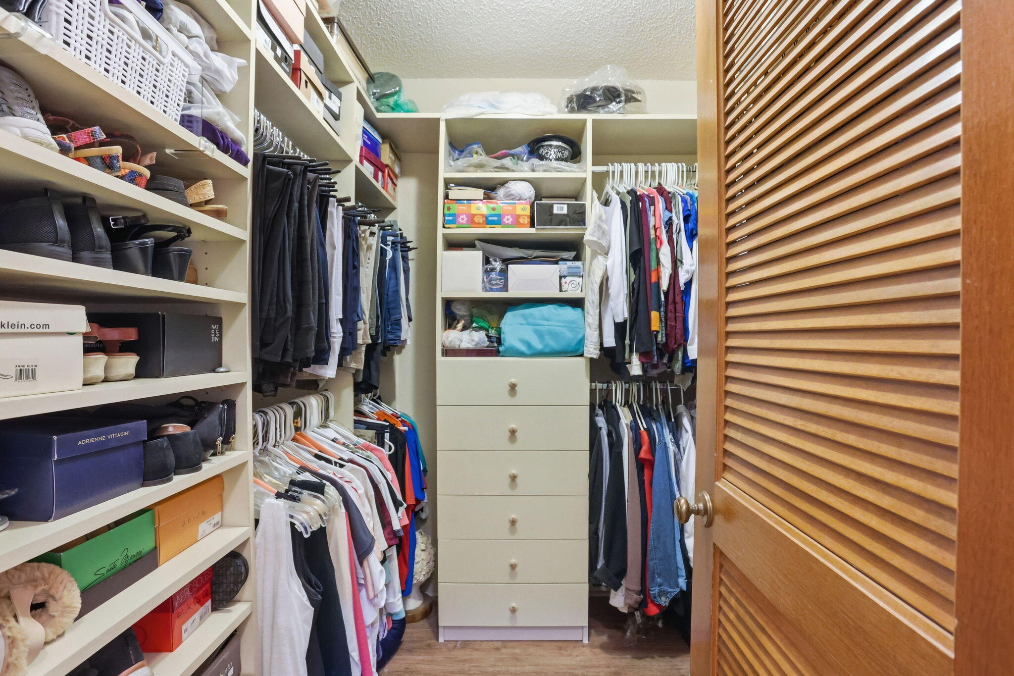 1960 Northwest 25th Street Boca Raton, FL 33431 - Photo 30 of 50 a view of walk in closet with clothes and shoes