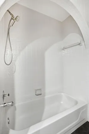 a bathroom with a bath tub with a shower