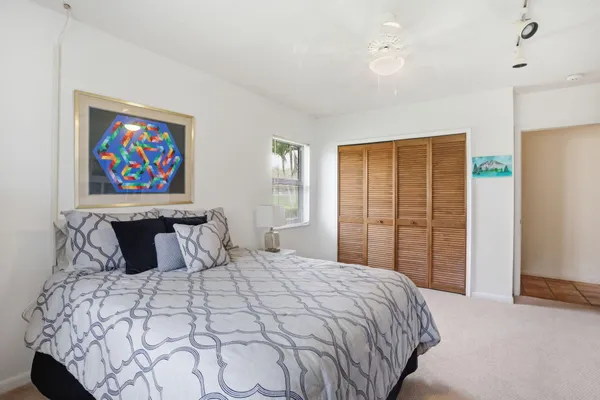 a bedroom with a large bed and a window