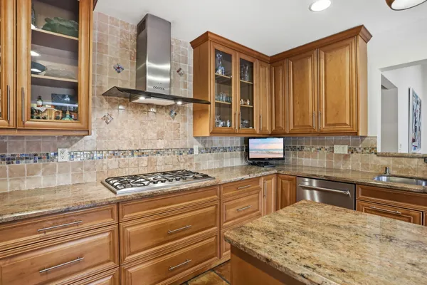 a kitchen with stainless steel appliances granite countertop a sink stove and cabinets