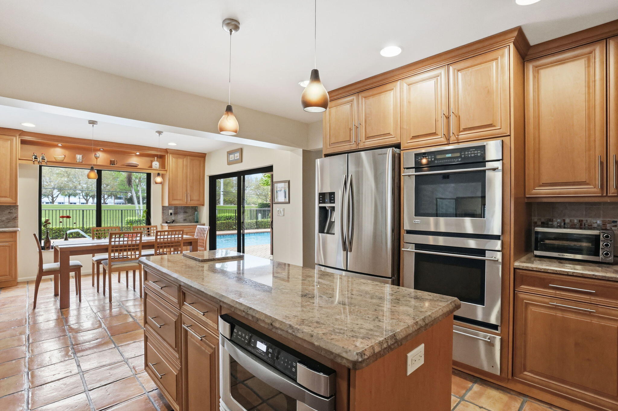 1960 Northwest 25th Street Boca Raton, FL 33431 - Photo 8 of 50 a kitchen with stainless steel appliances granite countertop a stove a refrigerator and a microwave