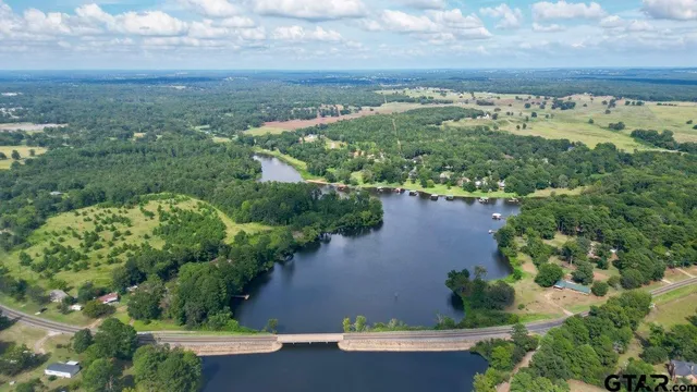 an aerial view of a house with a yard and lake view