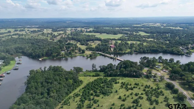 an aerial view of a houses with a lake view