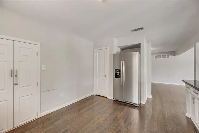 a view of an empty room and wooden floor