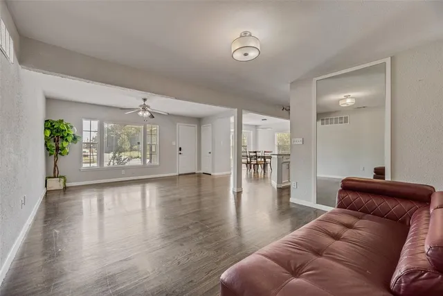 a living room with furniture and wooden floor