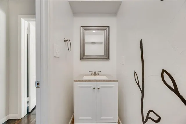 a bathroom with a sink and mirror