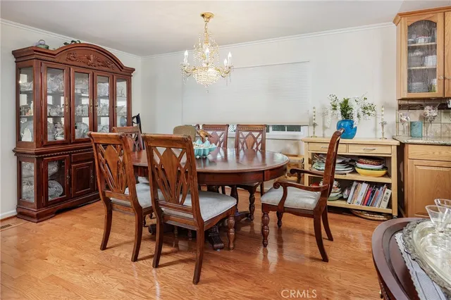 a view of a dining room with furniture and a chandelier