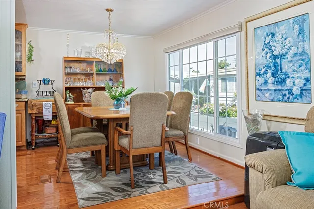 a dining room with furniture a rug and wooden floor