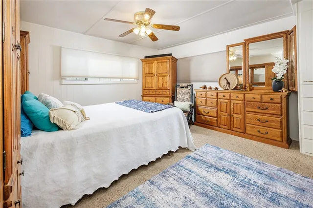 a bedroom with a bed dresser and a window