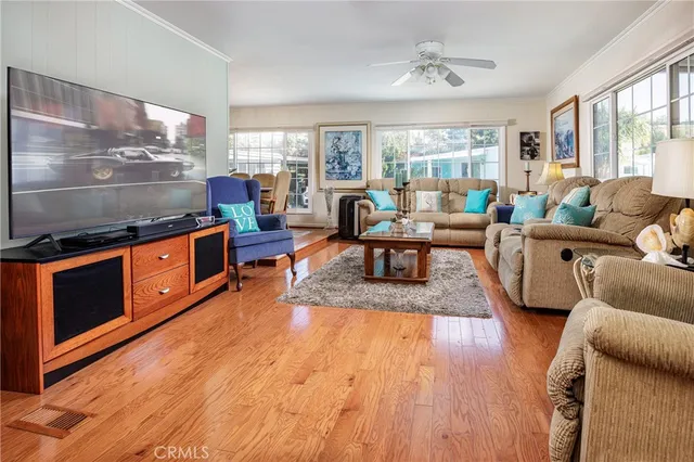 a living room with furniture windows and wooden floor