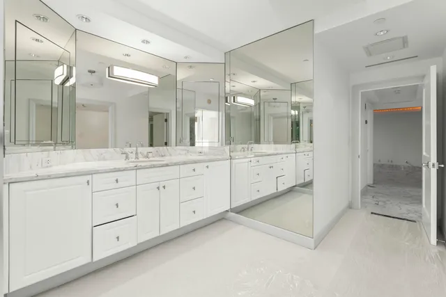 a spacious bathroom with a granite countertop sink mirror and double